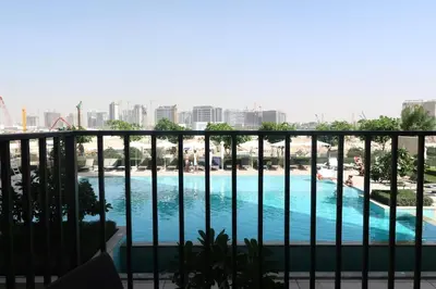 a view of a swimming pool from a balcony at Designed 2BR in Socio Dubai Hills in Dubai