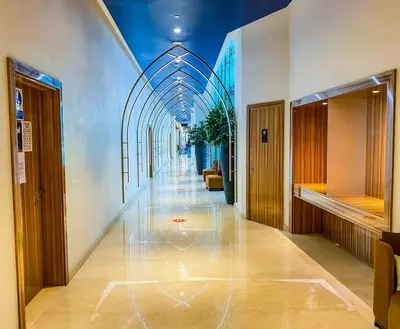 a hallway with a long hallway with a glass ceiling at Contemporary Studio in Business Bay - Burj Khalifa View - Gym & Pool in Dubai