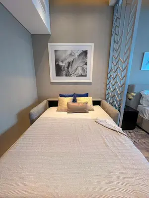 a bedroom with a large bed in a room at Contemporary Studio in Business Bay - Burj Khalifa View - Gym & Pool in Dubai