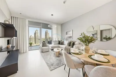 a kitchen and living room with a table and chairs at High-Floor 1BR Facing the Marina and City, Minutes from Marina Beach with Easy Access to Marine Transport, LIV Marina, Dubai Marina by Deluxe Holiday Homes in Dubai