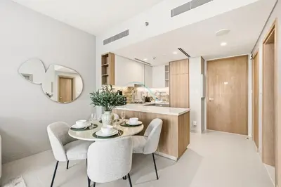 a kitchen and dining room with a table and chairs at High-Floor 1BR Facing the Marina and City, Minutes from Marina Beach with Easy Access to Marine Transport, LIV Marina, Dubai Marina by Deluxe Holiday Homes in Dubai