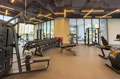a gym with rows of treadmills and machines at High-Floor 1BR Facing the Marina and City, Minutes from Marina Beach with Easy Access to Marine Transport, LIV Marina, Dubai Marina by Deluxe Holiday Homes in Dubai