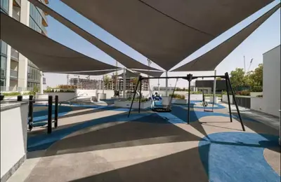 a playground in a building with swings at Spacious apartment with Burj Khalifa view close to Dubai mall! in Dubai