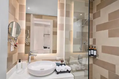 a bathroom with a sink and a shower at Seven Palm Residence with Beach access in Dubai