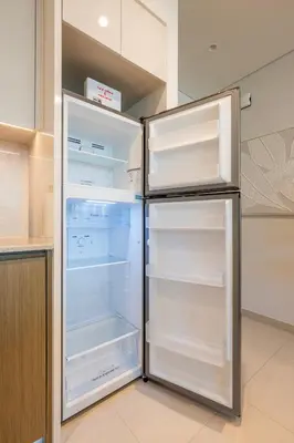 a refrigerator with its door open in a kitchen at Stunning 1 Bedroom Panoramic Views at Burj Royale in Dubai