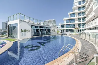 a large swimming pool in front of a building at Bloomfields Classic 2Br With Private Pool Samana in Dubai
