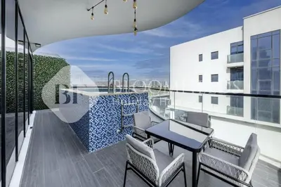 a balcony with a table and chairs on a building at Bloomfields Classic 2Br With Private Pool Samana in Dubai