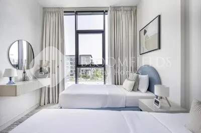 a bedroom with two beds and a large window at Bloomfields Classic 2Br With Private Pool Samana in Dubai