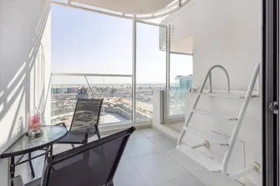 a room with a table and chairs and a window at Opalz by Danube,Dubai Science Park - Studio Apartment - Allsopp & Allsopp in Dubai