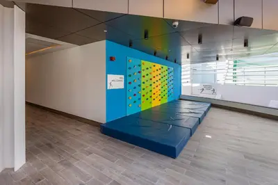 a room with a wall with a climbing wall at Opalz by Danube,Dubai Science Park - Studio Apartment - Allsopp & Allsopp in Dubai