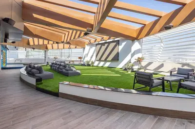an office lobby with couches and chairs and grass at Opalz by Danube,Dubai Science Park - Studio Apartment - Allsopp & Allsopp in Dubai