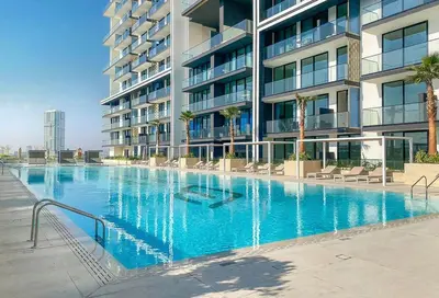 a large swimming pool in front of a building at BLVD Luxury 2BHK with Private Pool Near Circle Mall in Dubai