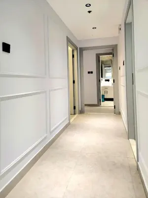 an empty hallway with white walls and a tile floor at Marina Residence tower A in Dubai