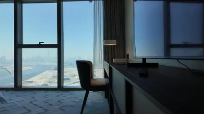 a room with a desk with a tv and a chair at Address Point Tower 2 in Dubai