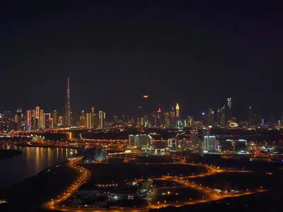 a view of a city at night with lights at Address Point Tower 2 in Dubai