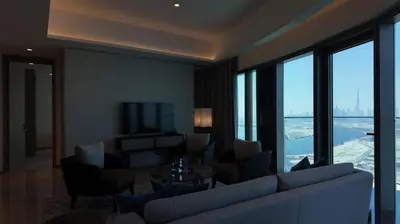 a living room with a couch and chairs and a television at Address Point Tower 2 in Dubai