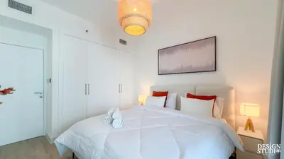 a bedroom with a white bed with two shoes on it at MARINA DIAMOND 6 by Design Studio in Dubai
