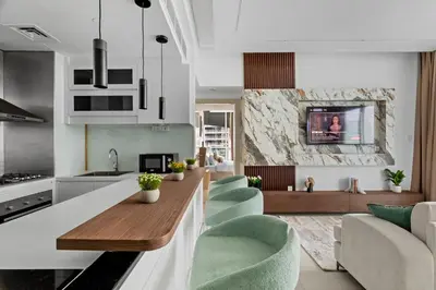 a kitchen and living room with a table and chairs at Modern 2BR Luxury Apartment with Downtown Dubai & Burj Khalifa Views in Dubai