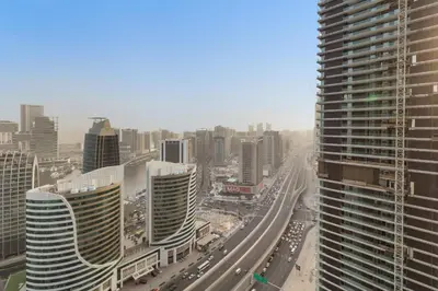 a view of a city with tall buildings and a highway at Modern 2BR Luxury Apartment with Downtown Dubai & Burj Khalifa Views in Dubai