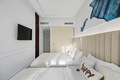 a bedroom with two beds and a tv on a wall at Modern 2BR Luxury Apartment with Downtown Dubai & Burj Khalifa Views in Dubai
