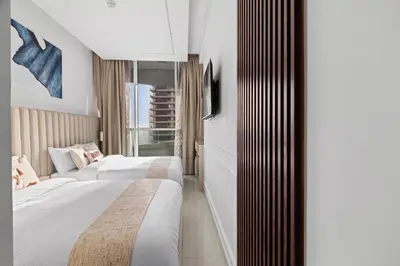 a hotel room with two beds and a window at Modern 2BR Luxury Apartment with Downtown Dubai & Burj Khalifa Views in Dubai
