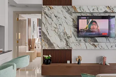 a living room with a television on a wall at Modern 2BR Luxury Apartment with Downtown Dubai & Burj Khalifa Views in Dubai