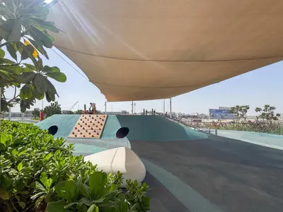 a skate park with a skateboard ramp under a canopy at Frank Porter - Golf Gate 1 in Dubai