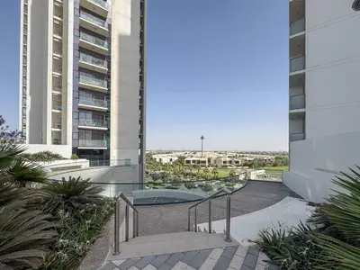 a stairway in a building with two tall buildings at Frank Porter - Golf Gate 1 in Dubai