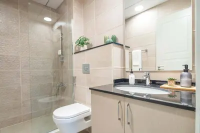 a bathroom with a toilet and a sink and a shower at Frank Porter - Polo Residence C5 in Dubai