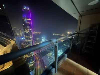 a view of a city at night with purple lights at Marina Princess Tower Dubai Apartment in Dubai
