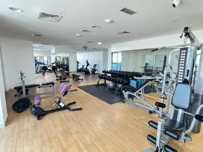 a gym with several treadmills and exercise equipment at Luxury Apartment Fully Furnished Jumeirah Garden City in Dubai