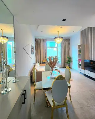 a living room with a table and chairs and a couch at MARINA VIEW TOWER a WING in Dubai