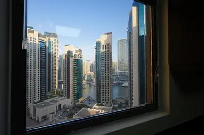 a view of a city skyline from a window at MARINA VIEW TOWER a WING in Dubai