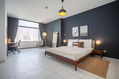 a bedroom with a bed and a table and chairs at Blueground DIFC pool gym DXB-505 in Dubai
