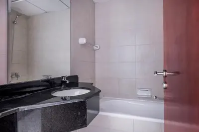 a bathroom with a sink and a bath tub at Blueground Icon Tower city view gym parking DXB-1332 in Dubai