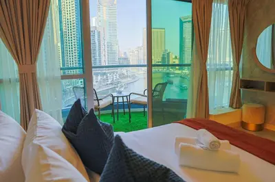 a hotel room with a bed with a view of the city at Rare apt with views of both Marina and JBR wheel in Dubai