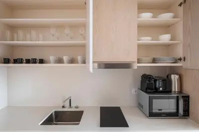 a kitchen with a sink and a microwave at Blueground The Palm Jumeirah pool nr Atlantis DXB-1719 in Dubai