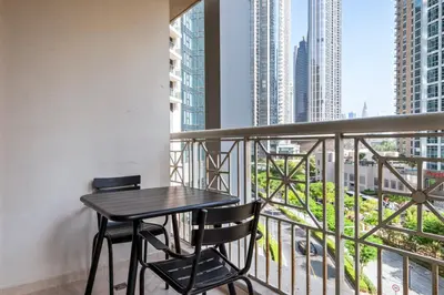 a balcony with a black table and two chairs at Blueground Downtown Dubai pool nr Burj Khalifa DXB-1735 in Dubai