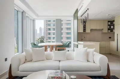 a living room with a white couch and a kitchen at Blueground Downtown Dubai pool nr Burj Khalifa DXB-1735 in Dubai