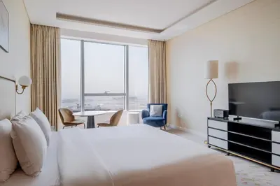 a hotel room with a bed and a television and a table at Blueground The Palm Jumeirah pool nr Atlantis DXB-1722 in Dubai