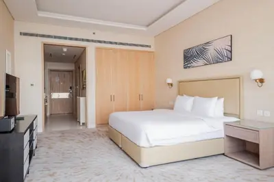 a hotel room with a bed and a television at Blueground The Palm Jumeirah pool nr Atlantis DXB-1722 in Dubai