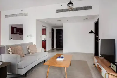 a living room with a couch and a table at Blueground JLT pool nr Lake DXB-1747 in Dubai