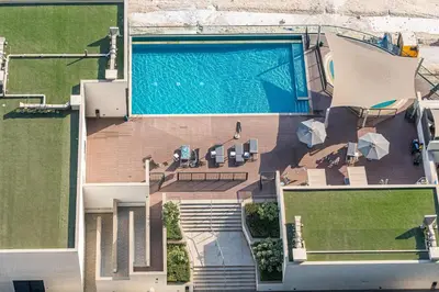 an overhead view of a house with a swimming pool at StayShort - Modern 1 Bed in Meydan Sleeps 4 in Dubai