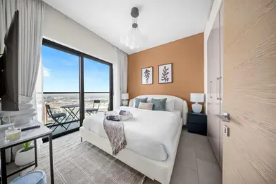 a bedroom with a large bed and a balcony at StayShort - Modern 1 Bed in Meydan Sleeps 4 in Dubai