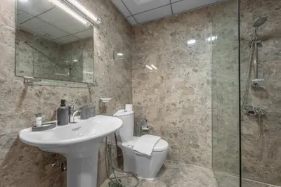 a bathroom with a toilet and a sink and a shower at StayShort - Chic Studio Apartment in JVC Sleeps 4 in Dubai