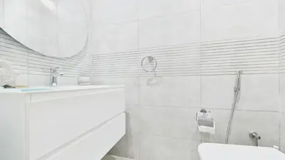 a bathroom with a sink and a toilet and a mirror at Spacious 2 BR with Sea and Marina View Bahar JBR in Dubai