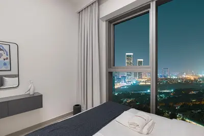 a bedroom with a large window with a city view at Modern 2BR Apartments near Dubai Mall, Downtown in Dubai