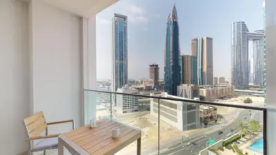 a balcony with a table and a view of a city at 2BR - Private Cinema - Pool - Walk to Burj Khalifa in Dubai