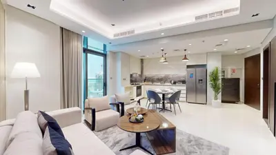 a living room with a couch and a table at Vacationer l Modern 1 Bedroom l City Views l Prime Location in Dubai
