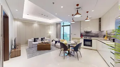 a kitchen and living room with a table and chairs at Vacationer l Modern 1 Bedroom l City Views l Prime Location in Dubai